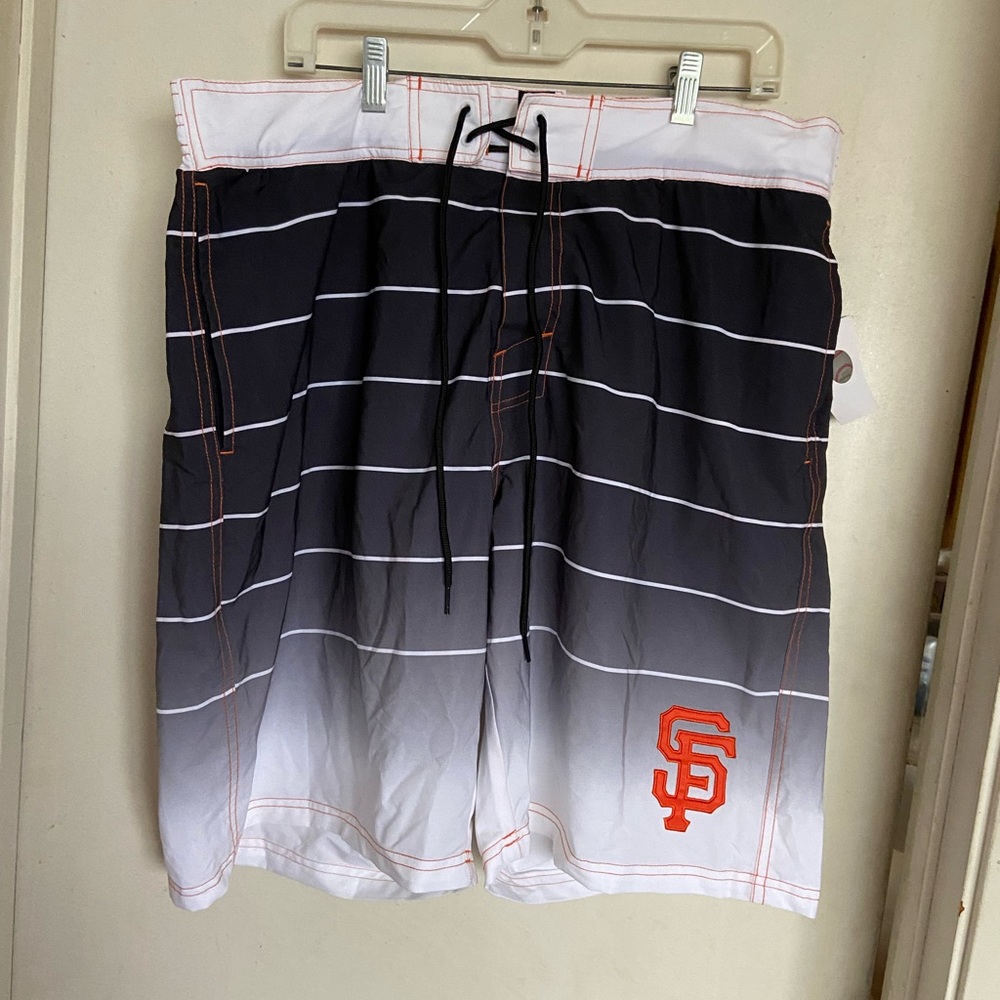 San Francisco Giants swim trunks.